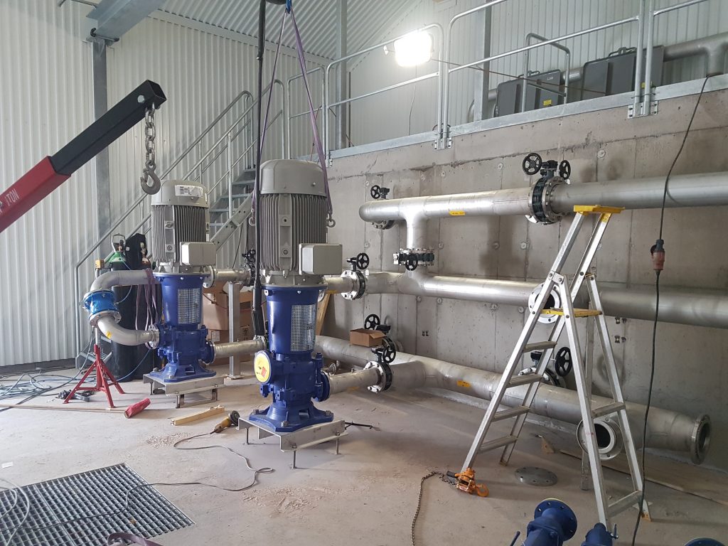 Two industrial pumps installed in a process piping pump station